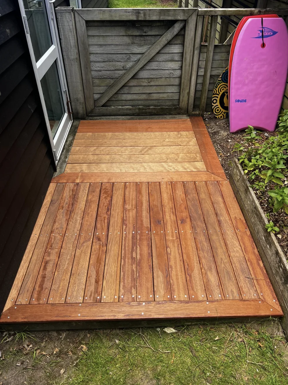 Renewed hardwood entry deck with picture-frame detail